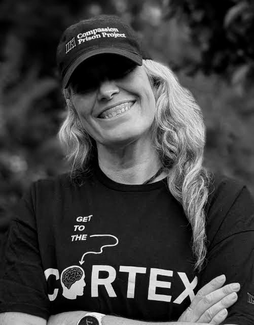 Nina Zolezzi wearing a Compassion Prison Project cap